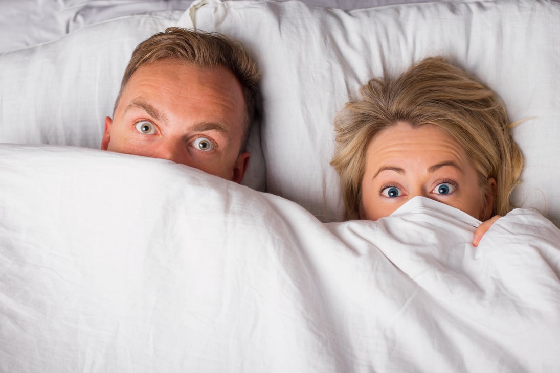 Couple in Bed Covering Blanket