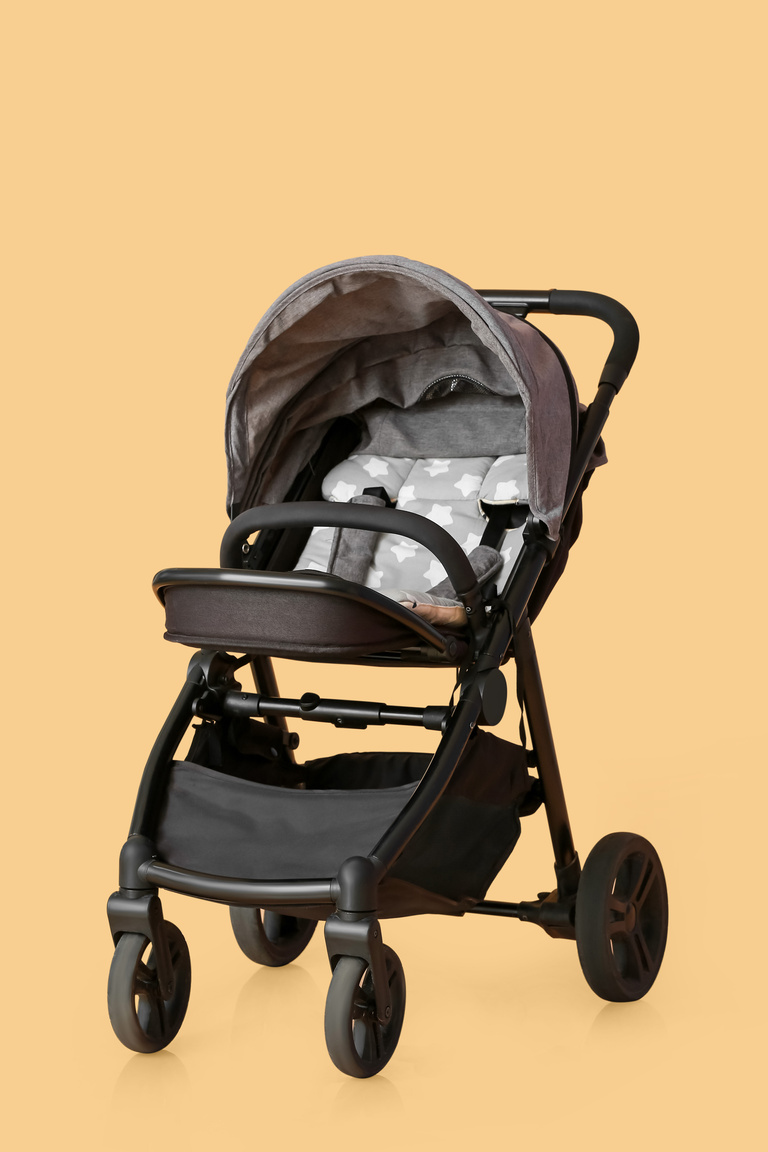Modern Baby Stroller on Color Background